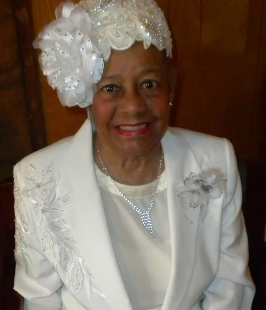 Big Mama smiling in a white outfit