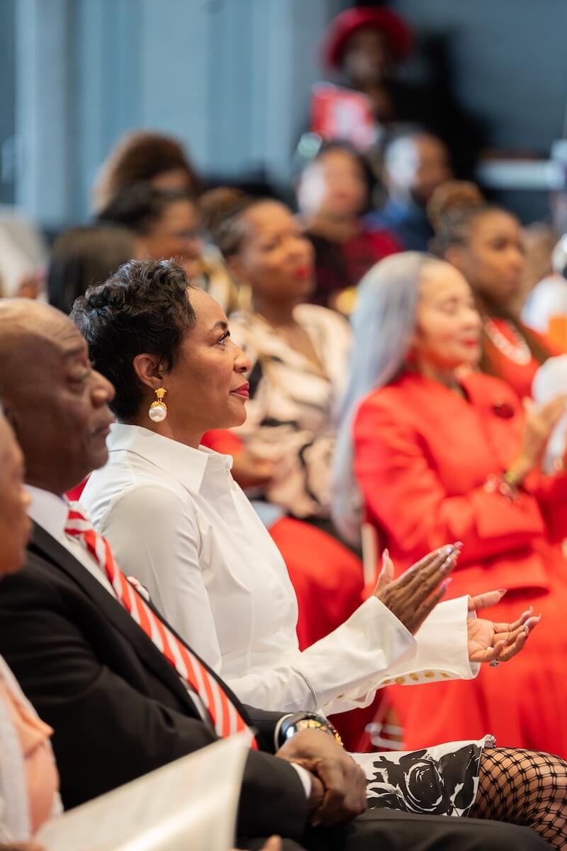 Guests clapping at Paint Your Lips Red Event