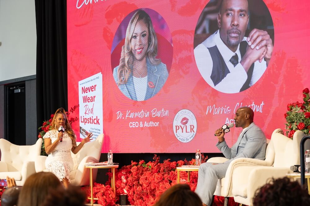 Karmetria Burton and Morris Chestnut on Stage speaking into microphones